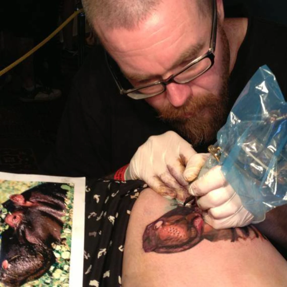 Vance tattooing a hippo portrait on a client's shoulder at The Inksmith studio